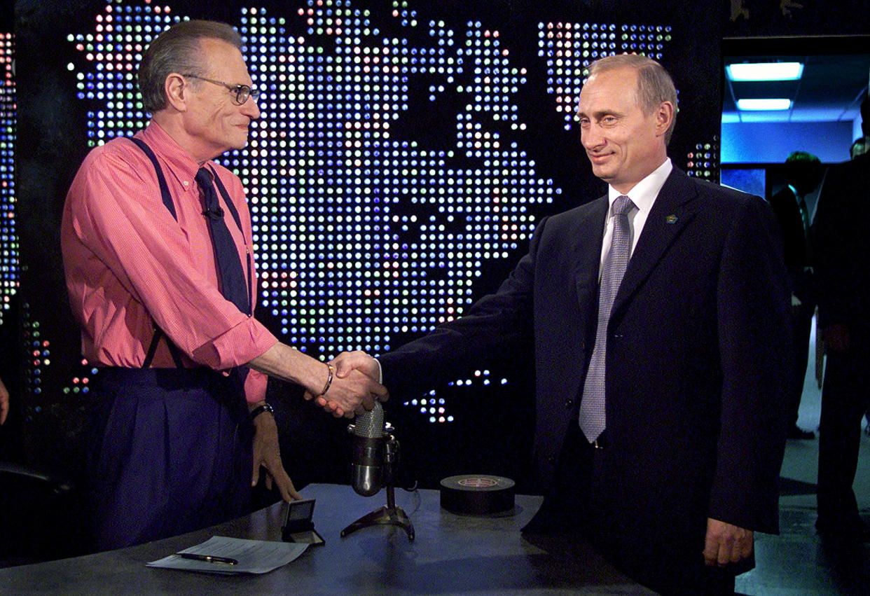 Russian President Vladimir Putin shakes hands with Larry King 