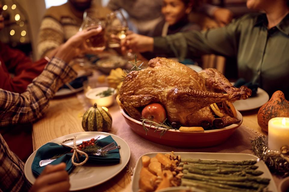 Close up of Thanksgiving turkey during family dinner at dining table.