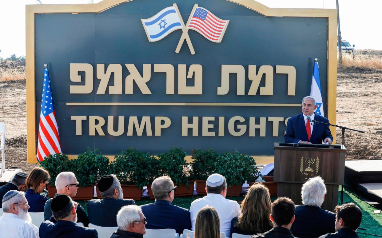 Israeli Prime Minister Benjamin Netanyahu gives a speech before the newly-unveiled sign for the new settlement of "Ramat Trump", or "Trump Heights" in English, named after the incumbent US President during an official ceremony in the Israeli-annexed Golan Height - AFP