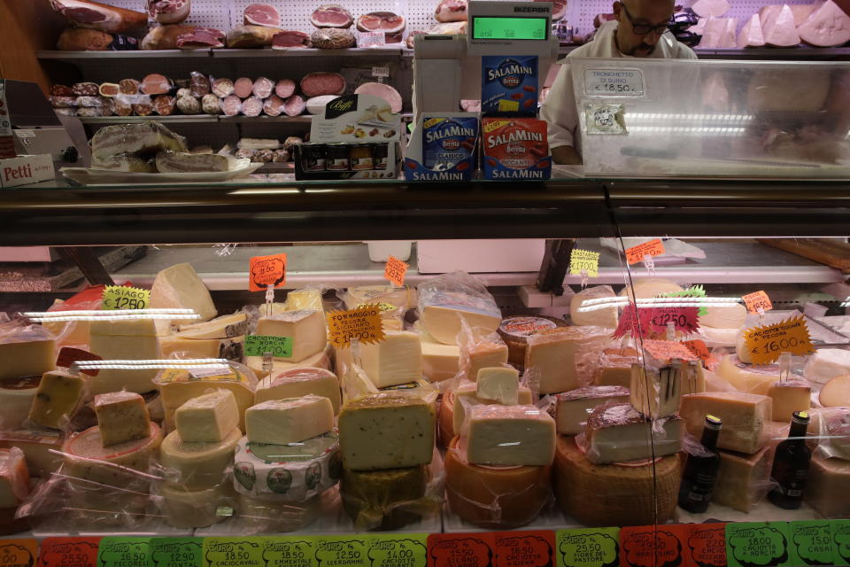 FILE - In this Oct. 3, 2019, file photo blocks of Italian cheese are on sale in a deli in Rome. The tariffs the Trump administration is about to impose on wine, liquor and cheese from Europe couldn’t come at a worse time for small retailers. (AP Photo/Alessandra Tarantino, File)