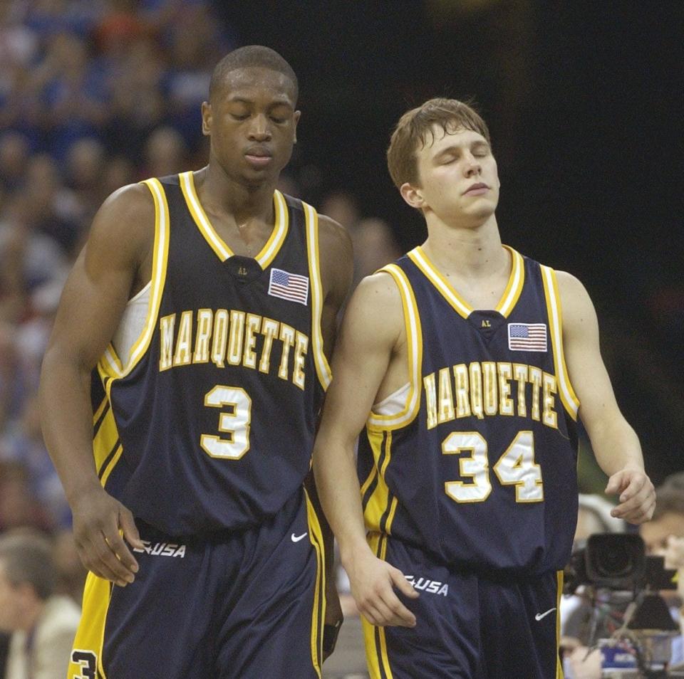 Dwyane Wade and Travis Diener walk off the court after falling to Kansas in the national semifinal April 5, 2003.