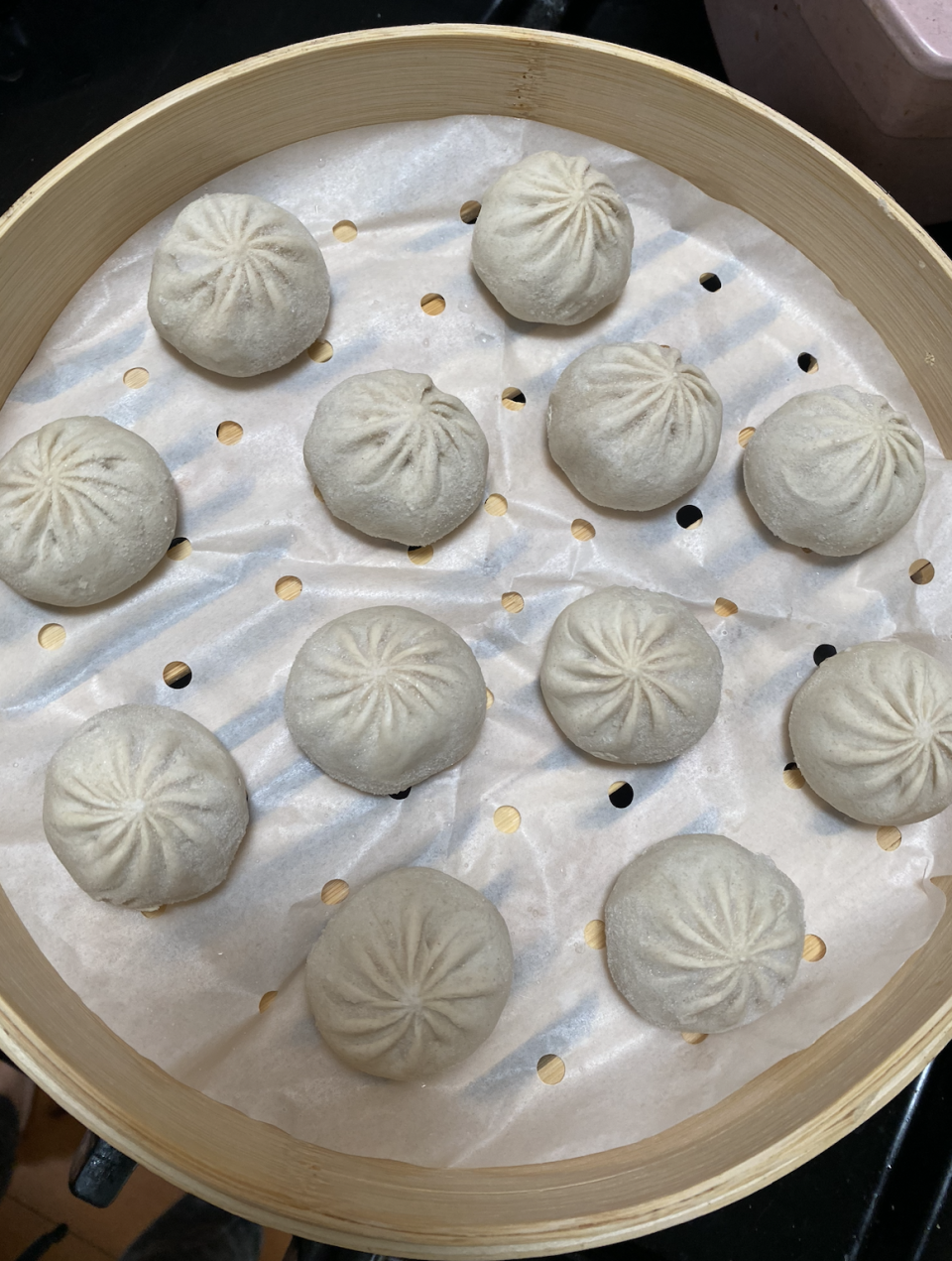 soup dumplings in a bamboo steam basket