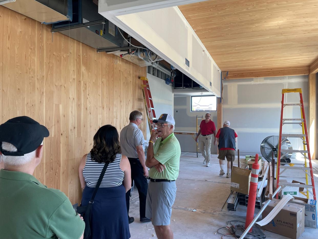 People tour the new Monmouth city hall under construction in July. Monmouth residents will pay more in taxes due in part to the voter-approved city hall construction bond.