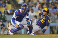 Milwaukee Brewers' Christian Yelich slides in to home to score off of a double hit by Eduardo Escobar during the third inning of a baseball game against the Los Angeles Dodgers Friday, Sept. 1, 2021, in Los Angeles. Los Angeles Dodgers catcher Austin Barnes is at left. (AP Photo/Ashley Landis)