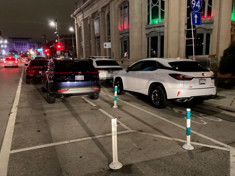 A car is parked in one of Milwaukee's newer bike lanes on East Kilbourn Avenue and North King Drive near the Milwaukee County Historical Society. The bike lanes are part of an effort to make streets more welcoming to cyclists and safer for everyone.