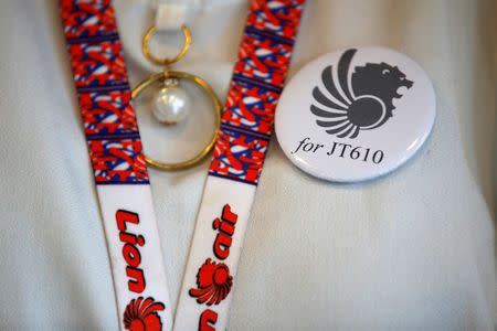 FILE PHOTO: A flight attendant of Lion Air wears a pin commemorating Lion Air flight JT610 as she prepares for a news conference about the recovery process at a hotel in Jakarta, Indonesia, November 5, 2018. REUTERS/Willy Kurniawan