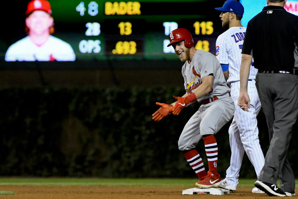 St. Louis Cardinals' Harrison Bader, third from right, reacts after hitting an RBI-double as Chicago Cubs second baseman Ben Zobrist, second from right, looks on during the sixth inning of a baseball game Thursday, Sept. 19, 2019, in Chicago. (AP Photo/Matt Marton)