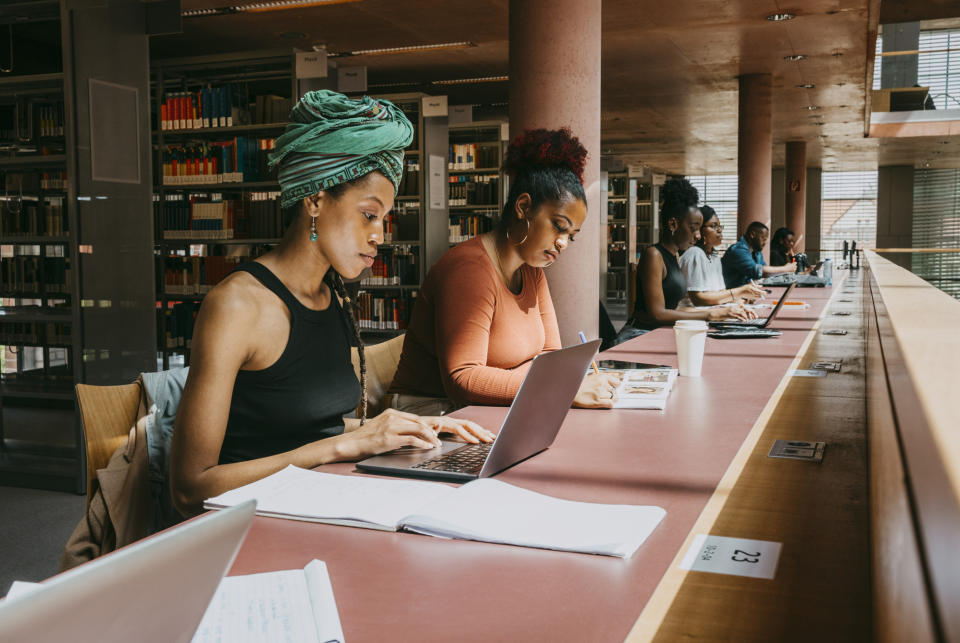 Two women are studying in the library