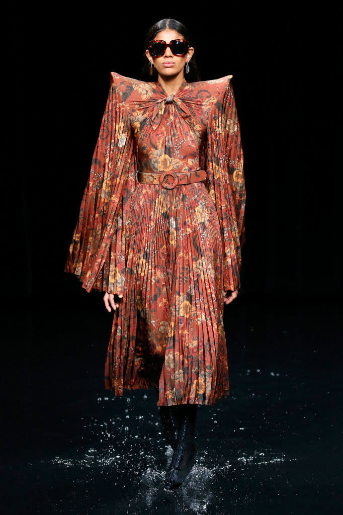 A model walking along a wet runway