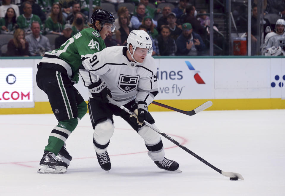 Dallas Stars center Jacob Peterson (40) and Los Angeles Kings left wing Carl Grundstrom (91) vie for the puck in the first period of an NHL hockey game Friday, Oct. 22, 2021, in Dallas. (AP Photo/Richard W. Rodriguez)