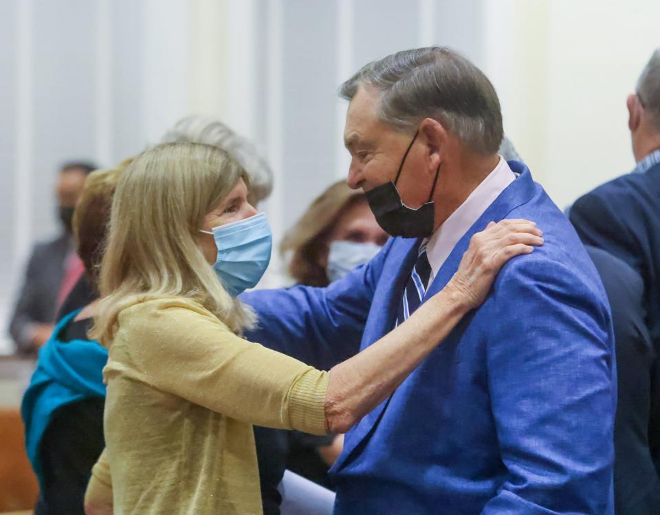 Bobbie Lindsay and Lew Crampton congratulate one another after each received nominations for seats on the Town Council during the Town Caucus Dec. 7.