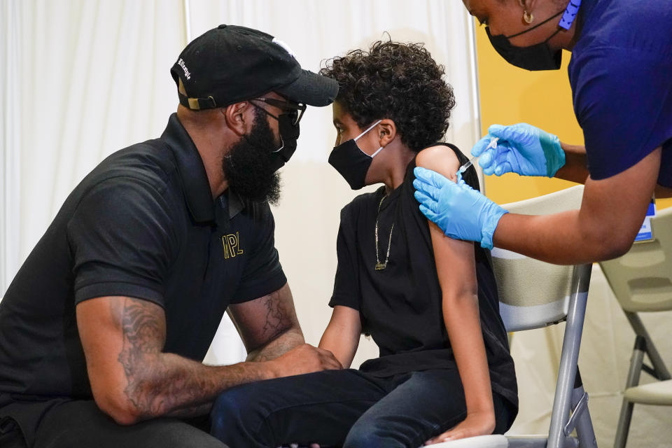 A 9-year-old child receives a dose of the COVID vaccine.