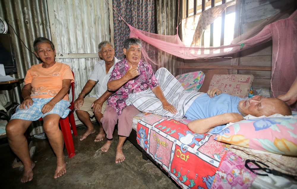 The senior citizen siblings in their dilapidated wooden house. — Picture by Farhan Najib