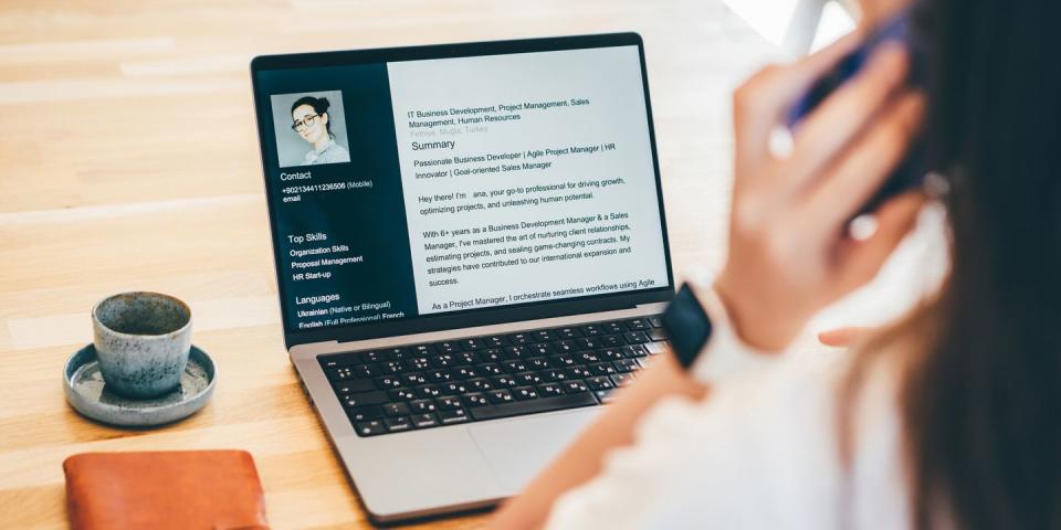 a young woman looking at her cv on a laptop