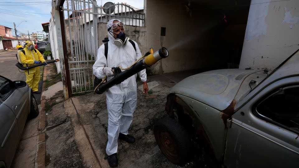 Public health workers spray insecticide during a fumigation campaign in the Ceilandia neighborhood of Brasilia, Brazil, Friday, Feb. 16, 2024. - Eraldo Peres/AP