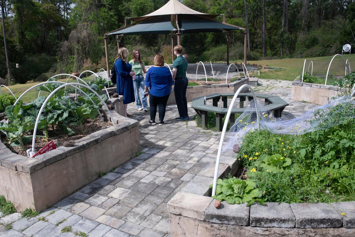 Student ambassadors give future students a tour of the Community Garden on the UWF Campus on Thursday, March 23, 2023. The Community Garden will soon be fertile ground for performances and events.