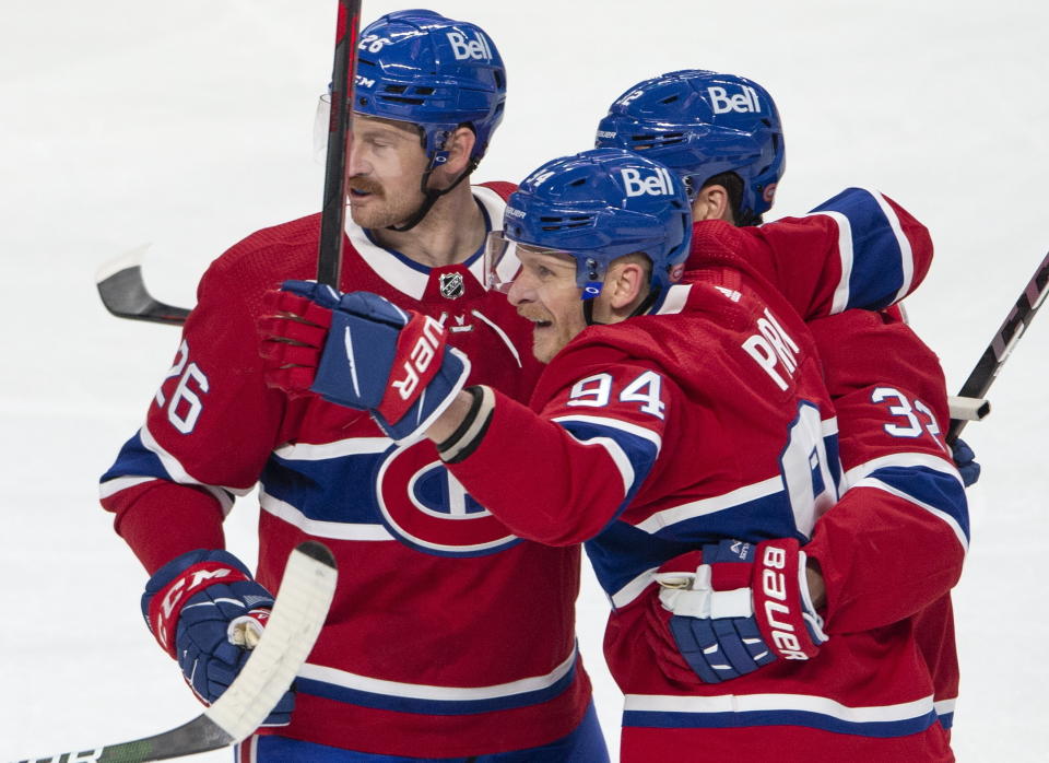 Montreal Canadiens' Corey Perry (94) celebrates his goal with teammates Jeff Petry (26) and Eric Gustafsson (32) during the first period of an NHL Stanley Cup playoff hockey game against the Winnipeg Jets, in Montreal, Sunday, June 6, 2021. (Ryan Remiorz/The Canadian Press via AP)