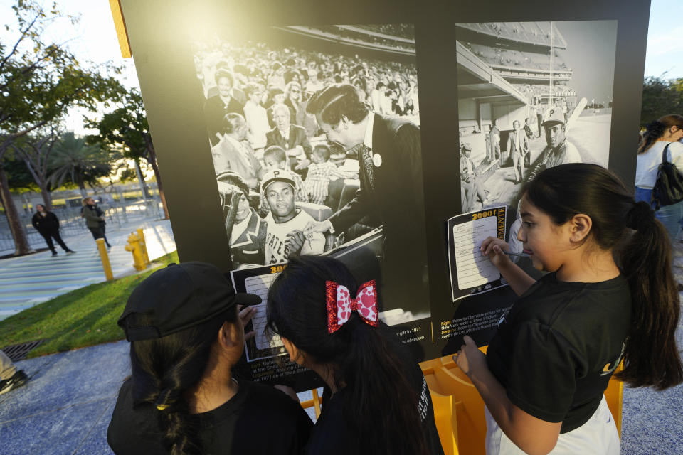 Kids from the Marlins Nike RBI youth sports program answer questions about the life of late Major League Baseball player Roberto Clemente, as they tour a traveling exhibit titled "3000" in a nod to Clemente's 3000 career hits, at Miami Marlins' loanDepot Park in Miami, Wednesday, Jan. 31, 2024. The tribute to the Pittsburgh Pirates outfielder will be on display at the park during baseball's Caribbean Series, which runs from Feb. 1 through Feb. 9. (AP Photo/Rebecca Blackwell)