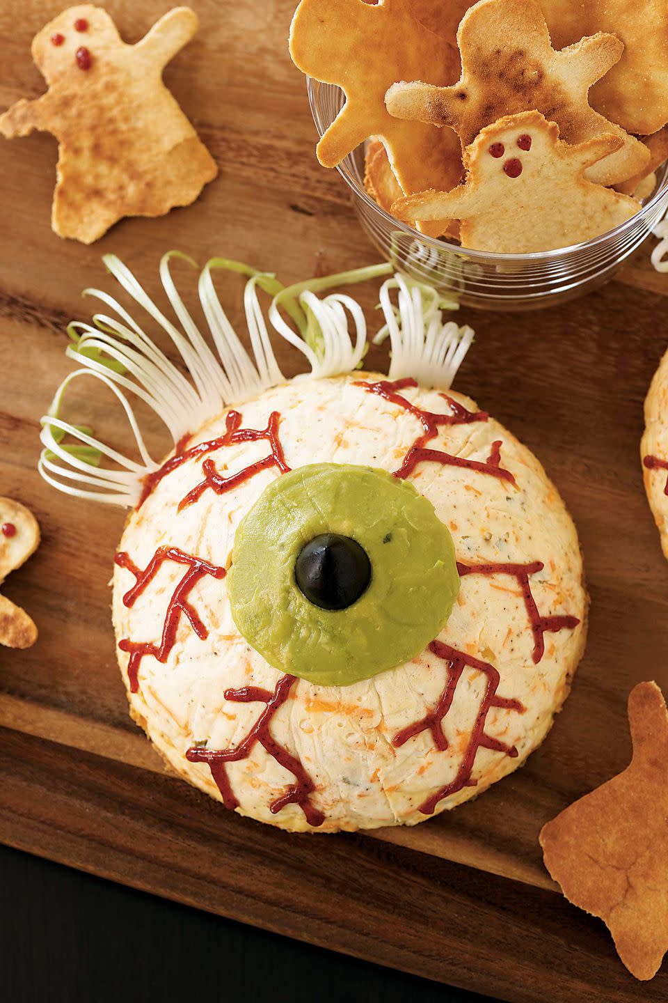 <p>Your guests will get an eye-full of delicious when they dig in to this cheesy peeper. Scallion eyelashes and a guacamole iris upgrade the party favorite. </p><p><strong><a rel="nofollow noopener" href="https://www.womansday.com/food-recipes/food-drinks/recipes/a10878/eyeball-cheesecakes-recipe-122182/" target="_blank" data-ylk="slk:Get the recipe.;elm:context_link;itc:0;sec:content-canvas" class="link ">Get the recipe.</a></strong></p>