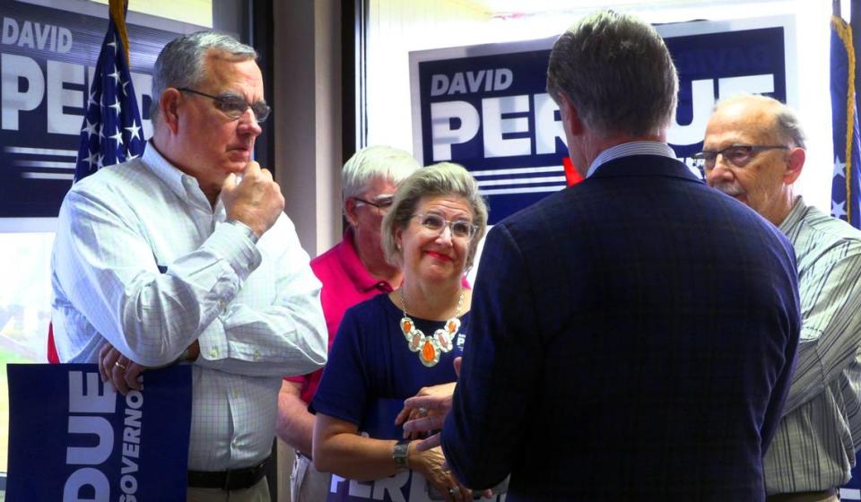 Republican gubernatorial candidate David Perdue( back to camera) speaks with supports during a Friday morning campaign stop at the Columbus Airport in Columbus, Georgia. 05/20/2022