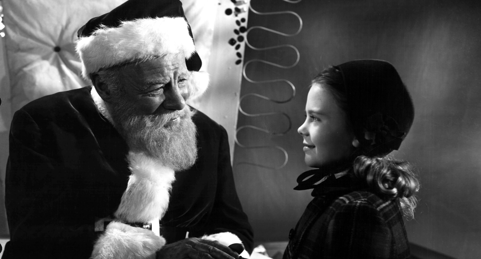 Santa and a little girl in a movie still from 'Miracle on 34th Street'