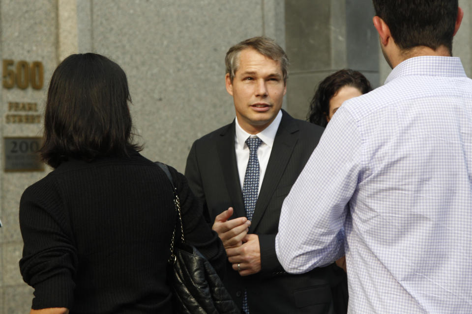 Shepard Fairey, center, arrives at Manhattan Federal court, Friday, Sept. 7, 2012 in New York. The artist who created the "HOPE" poster that came to symbolize Barack Obama's 2008 presidential campaign will be sentenced Friday, with prosecutors seeking a prison sentence for his criminal contempt conviction and his lawyers arguing that he should face no prison time for the misdemeanor charge. (AP Photo/Mary Altaffer)