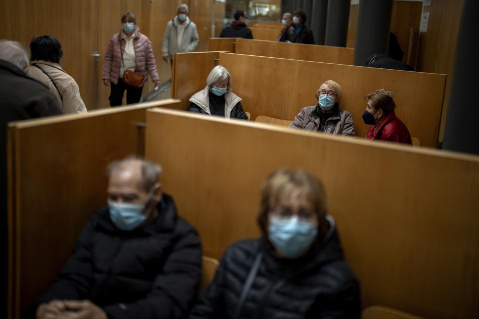 People wearing face masks as a precaution wait for a doctor appointment inside a hospital in Barcelona, Spain, Monday, Jan. 8, 2024. Regional and national health chiefs are meeting Monday to decide whether to extend mandatory mask—wearing to all health facilities following an epidemic outbreak of flu and other respiratory viruses that are putting a strain on the system. (AP Photo/Emilio Morenatti)