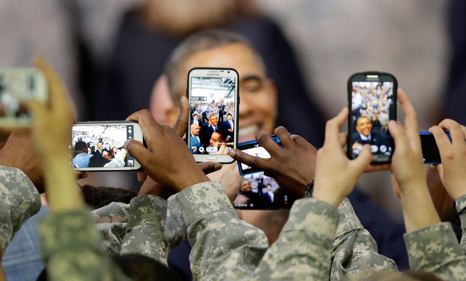 <p>U.S. military soldiers using their smartphones take pictures of U.S. President Barack Obama after delivering a speech at U.S. military base Yongsan Garrison in Seoul, South Korea, Saturday, April 26, 2014. (AP Photo/Lee Jin-man, Pool) </p>