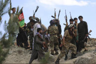 Afghan militiamen join Afghan defense and security forces during a gathering in Kabul, Afghanistan, Wednesday, June 23, 2021. Taliban gains in north Afghanistan, the traditional stronghold of the country's minority ethnic groups who drove the insurgent force from power nearly 20 years ago, has driven a worried government to resurrect militias whose histories have been characterized by chaos and widespread killing. (AP Photo/Rahmat Gul)