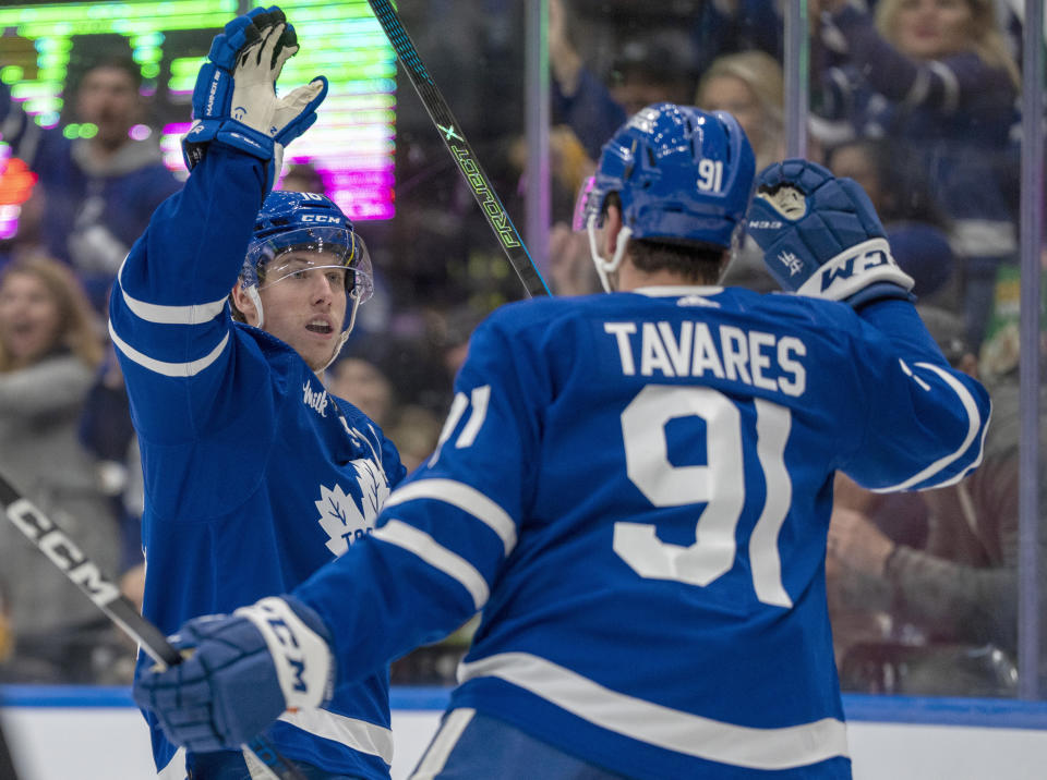 Toronto Maple Leafs right winger Mitch Marner (16) congratulates John Tavares for a goal against the Pittsburgh Penguins during the second period of an NHL hockey game Saturday, Dec. 16, 2023, in Toronto. (Frank Gunn/The Canadian Press via AP)