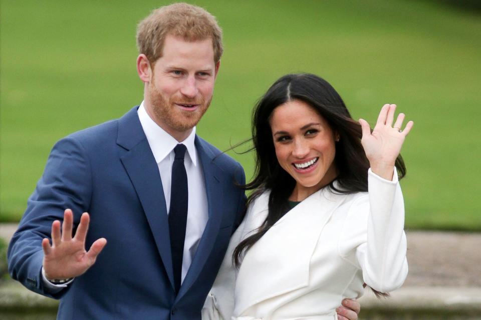 <p>DANIEL LEAL/AFP via Getty</p> Prince Harry and Meghan Markle in the Sunken Garden at Kensington Palace after announcing their engagement on Nov. 27, 2017.