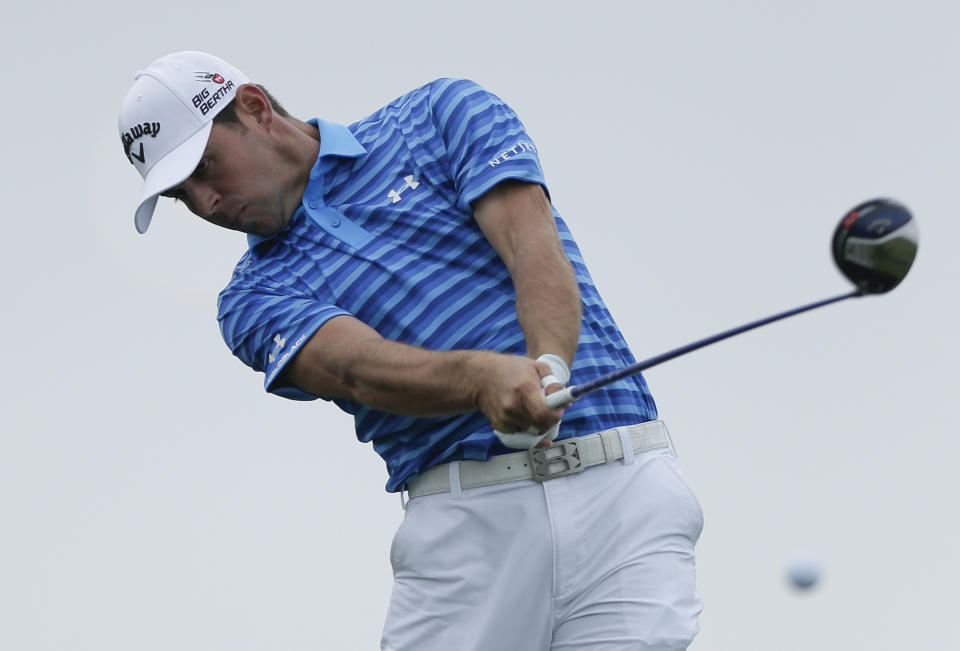 Gary Woodland hits his tee shot on the fourth hole of the South Course at Torrey Pines during the final round of the Farmers Insurance Open golf tournament Sunday, Jan. 26, 2014, in San Diego. (AP Photo/Gregory Bull)