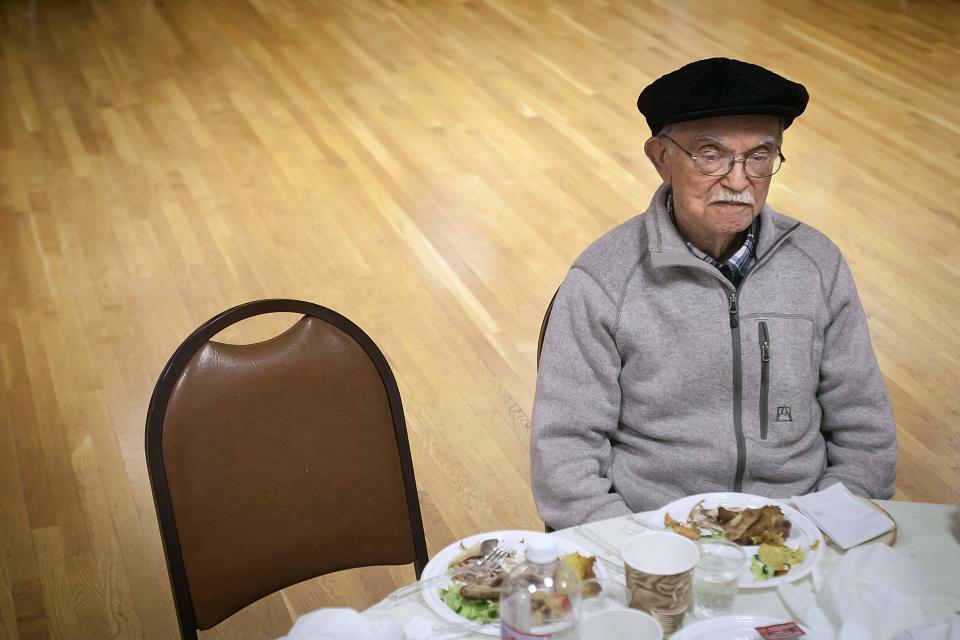 90 year old Holocaust survivor Hy Abrams sits at a lunch table in the Brooklyn borough of New York January 15, 2015. In a little leather book, the kind some men use to list lovers, Holocaust survivor Abrams keeps the names that still haunt him: Auschwitz, Plaszow, Mauthausen, Melk and Ebensee. It has been 70 years since the Soviet army liberated the Auschwitz concentration camp in Poland, where Abrams was taken at age 20 by German Nazi soldiers and separated from his mother, father, brother and three sisters. Picture taken January 15, 2015. To match AUSCHWITZ-ANNIVERSARY/USA REUTERS/Carlo Allegri (UNITED STATES - Tags: SOCIETY ANNIVERSARY CONFLICT)