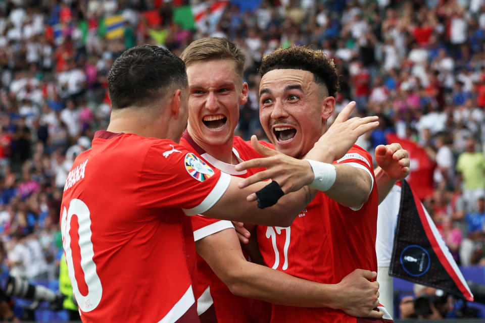 Switzerland's midfielder #17 Ruben Vargas (R) celebrates with teammates after scoring his team's second goal during the UEFA Euro 2024 round of 16 football match between Switzerland and Italy at the Olympiastadion Berlin in Berlin on June 29, 2024. (Photo by Ronny HARTMANN / AFP) (Photo by RONNY HARTMANN/AFP via Getty Images)