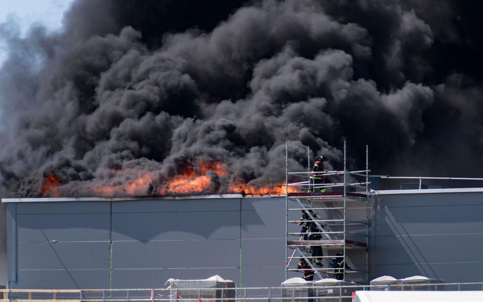 Firefighters try to extinguish the blaze at a Novo Nordisk construction site