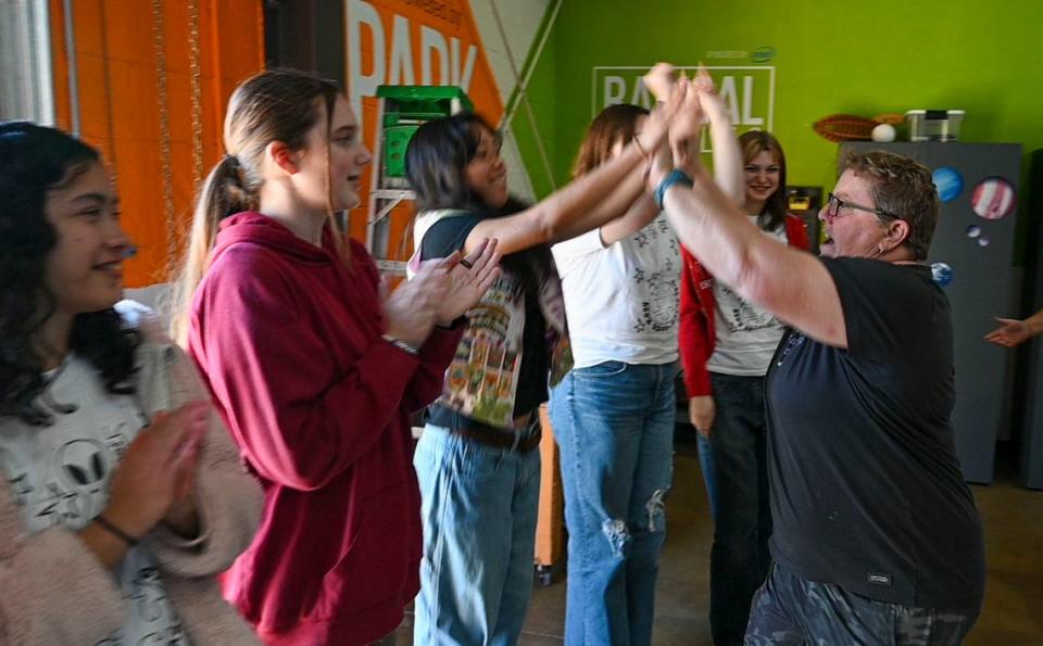 Jennifer Garland, a River City Amateur Radio Communications Society member, gives high fives to the Girl Scouts on Saturday after running tests to prepare to talk with astronauts on the ISS.