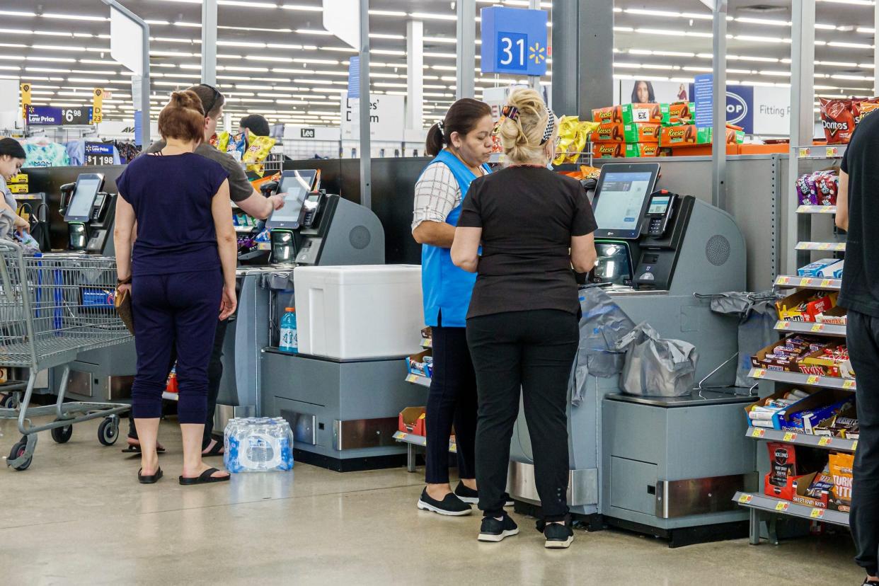 Customers at the self-checkout of a Walmart store.