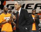 FILE - In this Wednesday, Jan. 26, 2011, file photo, former Oklahoma State coach Eddie Sutton, center, talks to fans during a ceremony honoring the 10th anniversary of the death of 10 members of the Oklahoma State basketball program in a plane crash, at halftime of an NCAA college basketball game between Oklahoma State and Texas in Stillwater, Okla. Sutton, the Hall of Fame basketball coach who led three teams to the Final Four and was the first coach to take four schools to the NCAA Tournament, died Saturday, May 23, 2020. He was 84. (AP Photo/Sue Ogrocki, File)