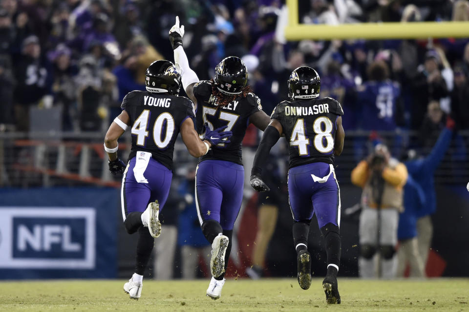 Baltimore Ravens inside linebacker C.J. Mosley, center, celebrates his interception with teammates Kenny Young, left, and Patrick Onwuasor in the second half of an NFL football game against the Cleveland Browns, Sunday, Dec. 30, 2018, in Baltimore. Baltimore Ravens won 26-24. (AP Photo/Gail Burton)