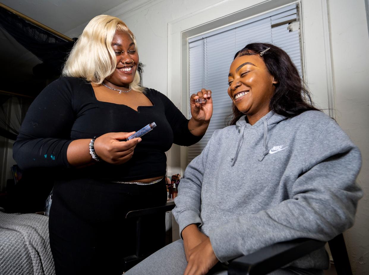 Keeping the Khemistry owner Jakayla Bridges, left, applies a natural lip oil she made on Kiara Massey on Friday, Sept. 22, 2023, in Milwaukee, Wis.