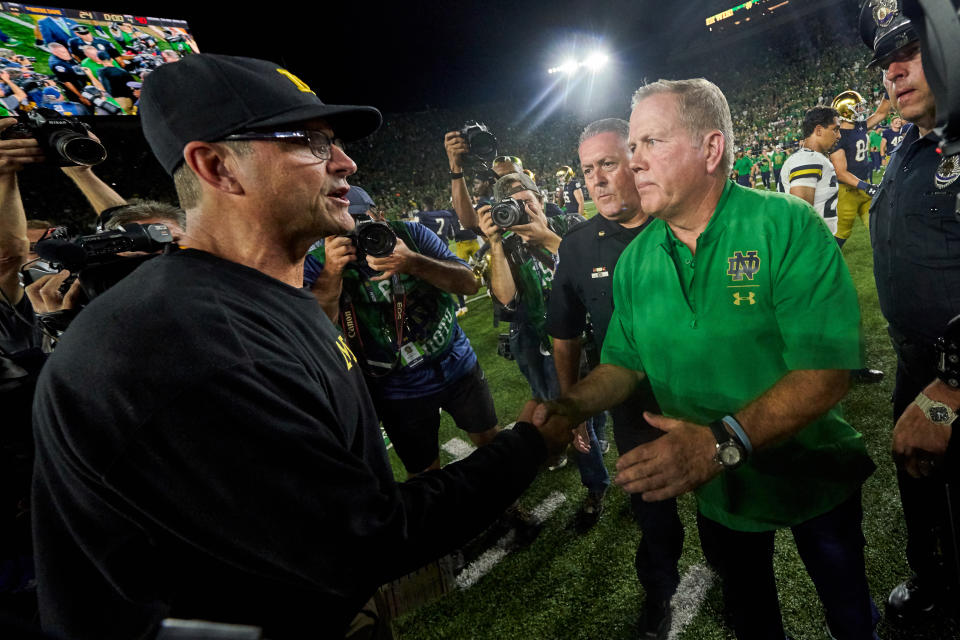 Michigan Wolverines head coach Jim Harbaugh shakes hands with Notre Dame Fighting Irish head coach Brian Kelly after their 2018 game. (Getty)