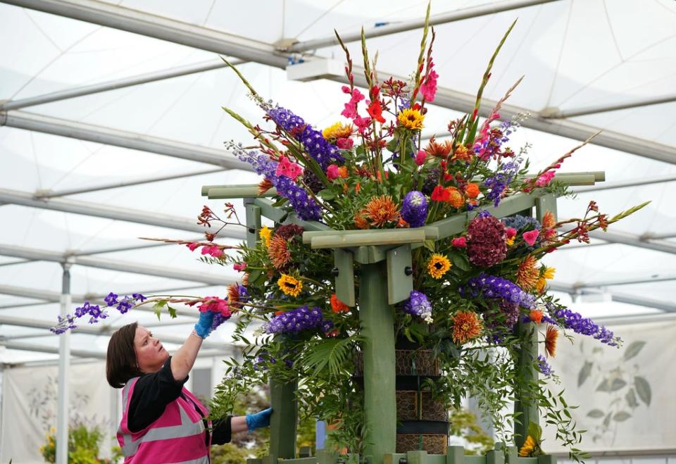 The final touches are completed on a giant display in the Co-op Communities in Bloom garden (Yui Mok/PA) (PA Wire)