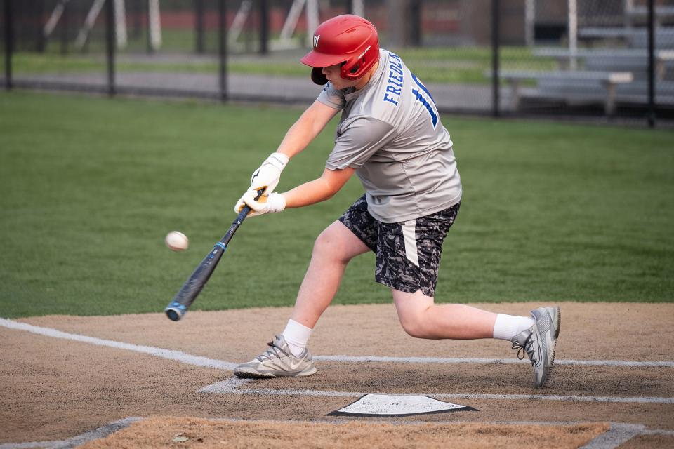 Auburn Senior Little League first baseman Matt Friedland drives the ball to center field during practice on Monday.