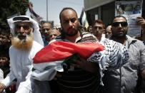 Relatives carry the body of 18-month-old Palestinian toddler Ali Saad Dawabsha, who died after his house was set on fire by Jewish settlers, during his funeral in the West Bank village of Duma on July 31, 2015