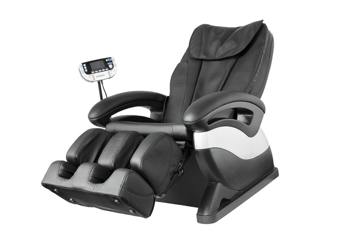 Black leather comfortable reclining massage chair. With Shiatsu, Tapping and Kneading therapeutic massages.