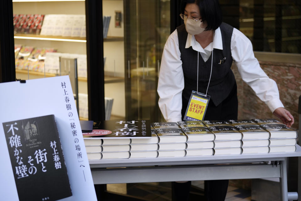 A shop clerk prepares to sell Japanese writer Haruki Murakami's new novel "The City and Its Uncertain Walls" on the first day for sale at Kinokuniya bookstore in Shinjuku district early Thursday, April 13, 2023, in Tokyo. (AP Photo/Eugene Hoshiko)