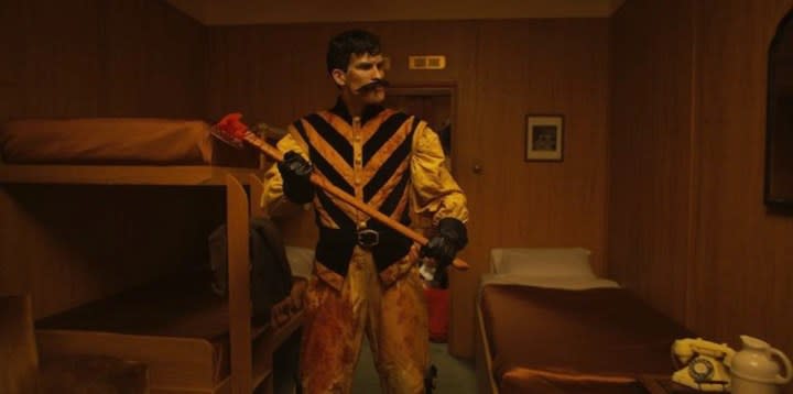 A man holds an ax in The Haunting of Queen Mary.