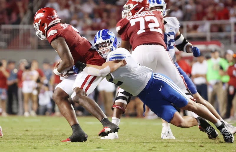 BYU linebacker Ben Bywater tries to sack Arkansas quarterback KJ Jefferson at Razorback Stadium.