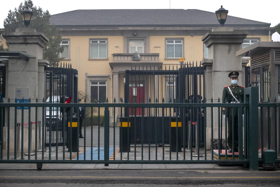 A Chinese paramilitary police officer stands guard outside the British Embassy in Beijing, Friday, March 26, 2021. China has announced sanctions on British individuals and entities following the U.K.'s joining the EU and others in sanctioning Chinese officials accused of human rights abuses in the Xinjiang region. (AP Photo/Mark Schiefelbein)