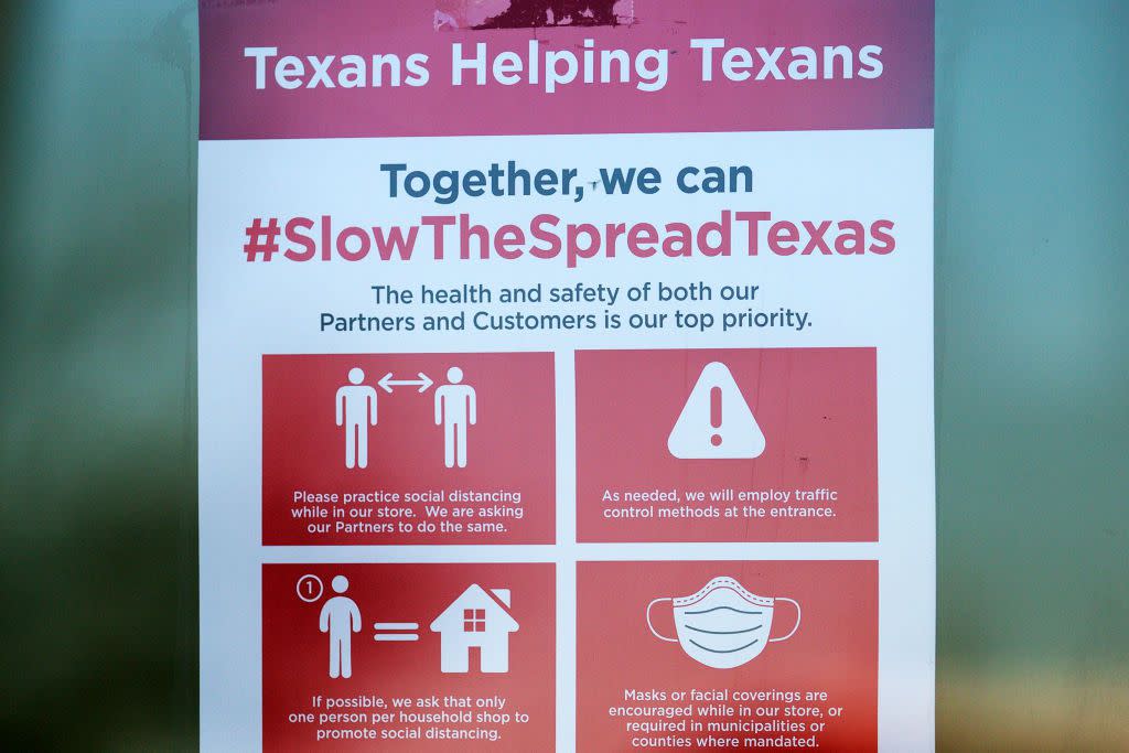 A Covid-19 restriction signs hang outside of H-E-B supermarket on March 3, 2021 in Austin, Texas. The popular Texas supermarket chain will not require customers to wear masks when the statewide mask mandate ends on March 10, 2021.